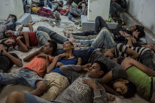 Young Egyptians detained at a police station sleep on the floor in Rosetta Egypt after rescued from a boat capsized off the Mediterranean coast near the Egyptian city of Alexandria Wednesday Sept. 21 2016