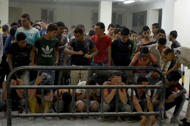 Survivors from a boat that capsized off Egypt's north coast are seen in a police station in Rashid in northern Egypt