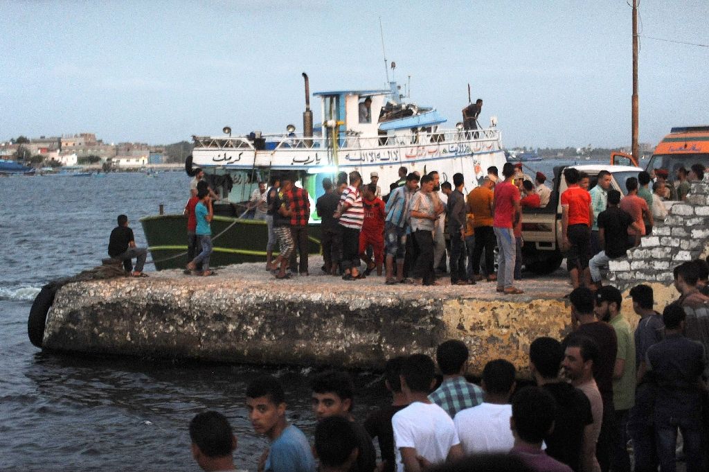 Egyptians gather at Rosett during a search operation after a boat carrying migrants capsized in the Mediterranean