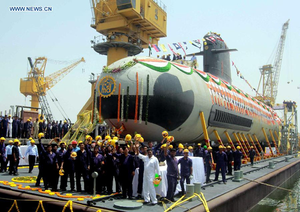 Employees stand near Indian Navy's first indigenously-built Scorpene attack submarine at Mazagon Dock in Mumbai India