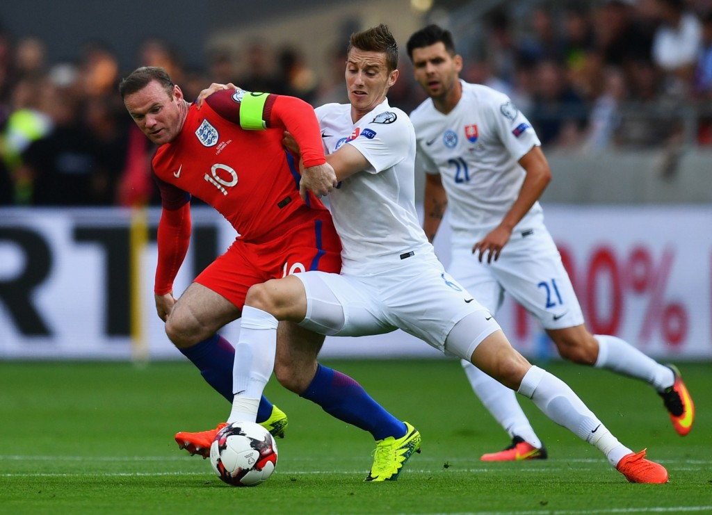 TRNAVA SLOVAKIA- SEPTEMBER 04 Wayne Rooney of England battles with Jan Gregus of Slovakia during the 2018 FIFA World Cup Group F qualifying match between Slovakia and England at City Arena