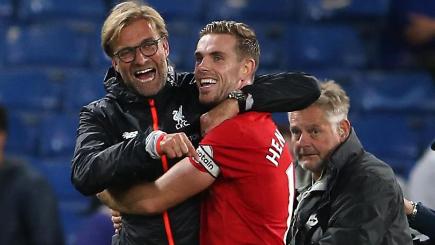 Liverpool manager Jurgen Klopp left celebrated with goalscorer Jordan Henderson after their win at Chelsea