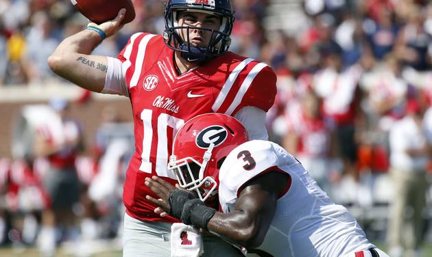 Mississippi quarterback Chad Kelly manages to make a pass as he is hit by Georgia linebacker Roquan Smith in the first half of their NCAA college football game Saturday Sept. 24 2016 in Oxford Miss