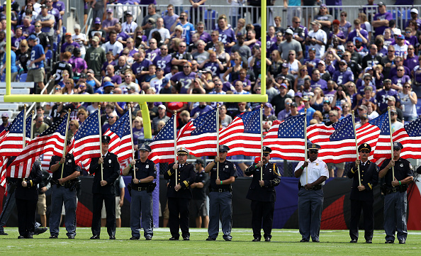 BALTIMORE MD- SEPTEMBER 11 First Responders carry flags prior to the Buffalo Bills vs. the Baltimore Ravens game at M&T Bank Stadium