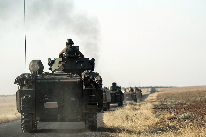 Turkish troops head to the Syrian border in Karkamis Turkey Saturday Aug. 27