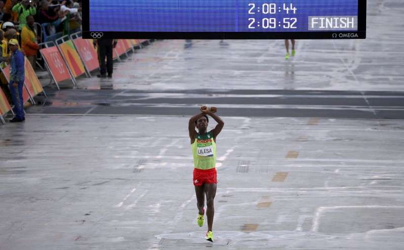 2016 Rio Olympics- Athletics- Final- Men's Marathon- Sambodromo- Rio de Janeiro Brazil- 21/08/2016. Feyisa Lilesa of Ethiopia celebrates as he wins silver REUTERS  Sergio Moraes