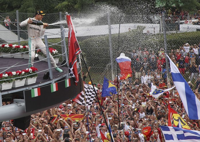 Mercedes driver Nico Rosberg of Germany celebrates on the podium after winning the Italian Formula One Grand Prix at the Monza racetrack Italy Sunday Sept. 4