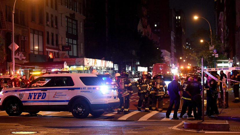 Police officers and firefighters respond to an explosion on Saturday at 23rd Street and 7th Avenue in the Chelsea neighborhood of New York City. Authorities say more than two dozen people have been taken to hospitals with injuries none of which are thoug