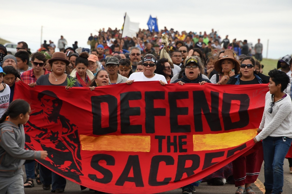 Native Americans march to a sacred site on Sunday that they say was disturbed by bulldozers working on the Dakota Access Pipeline near the encampment where hundreds of people have gathered to join the Standing Rock Sioux Tribe's protest