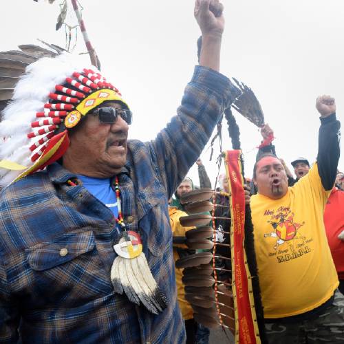 Horse left raises his fist with others while leading a march to the Dakota Access Pipeline site in southern Morton County North Dakota. Several hundred protesters marched about a mile up Hwy 1806 Friday Sept. 9 2016 from the prote