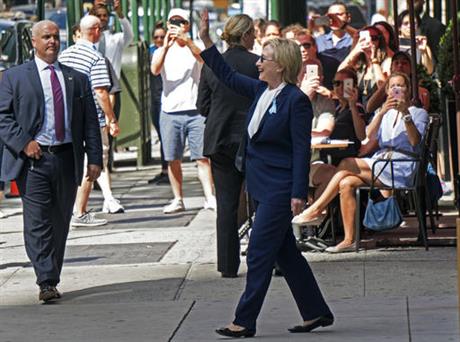 Democratic presidential candidate Hillary Clinton walks from her daughter's apartment building Sunday Sept. 11 2016 in New York. Clinton unexpectedly left Sunday's 9/11 anniversary ceremony in New York after feeling'overheated' according