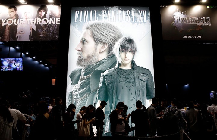 Visitors wait in line in front of an advertisement of the Final Fantasy XV video game at the Tokyo Game Show 2016