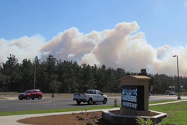 A large cloud of smoke rises above Vandenberg Air Force Base on Thursday due to a new vegetation fire burning in the heart of the base