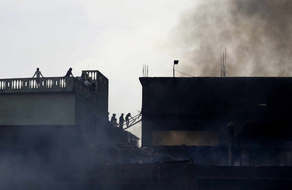 BANGLADESH DHAKA- SEPTEMBER 2016 Firefighters attempt to extinguish a fire at a garment packaging factory in the Tongi industrial area