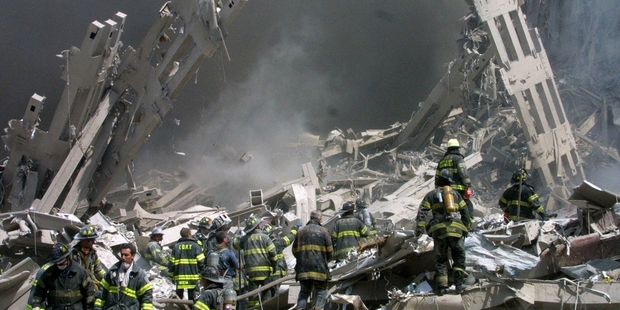 Firefighters make their way through the rubble after two airliners below crashed into the World Trade Centre