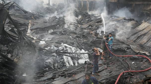 Firefighters work to put out the blaze at a packaging factory in the Tongi industrial area