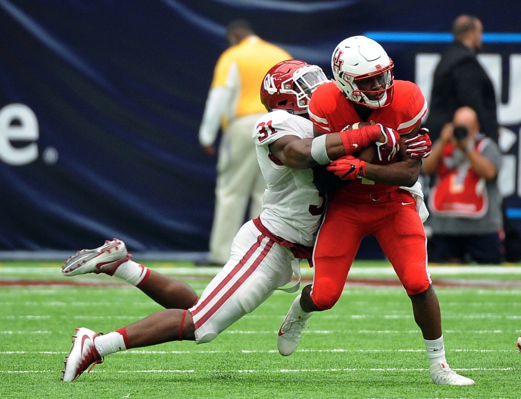 Houston quarterback Greg Ward Jr. is tackled by Oklahoma linebacker Ogbonnia Okoronkwo in the second half of Houston's 33-23 victory in an NCAA college football game in Houston. There's good news and bad