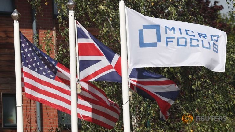 Flags fly outside the offices of Micro Focus in Newbury     
   Enlarge  Caption