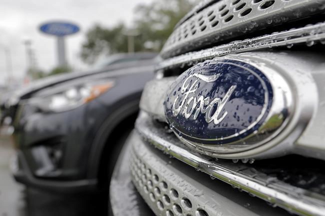 Ford vehicles sit on the lot at a car dealership in Brandon Fla. Ford Motor Co. expects its pretax profit to fall in 2017 but improve in 2018 as it invests in emerging businesses. Ford updated its outlook Wednes