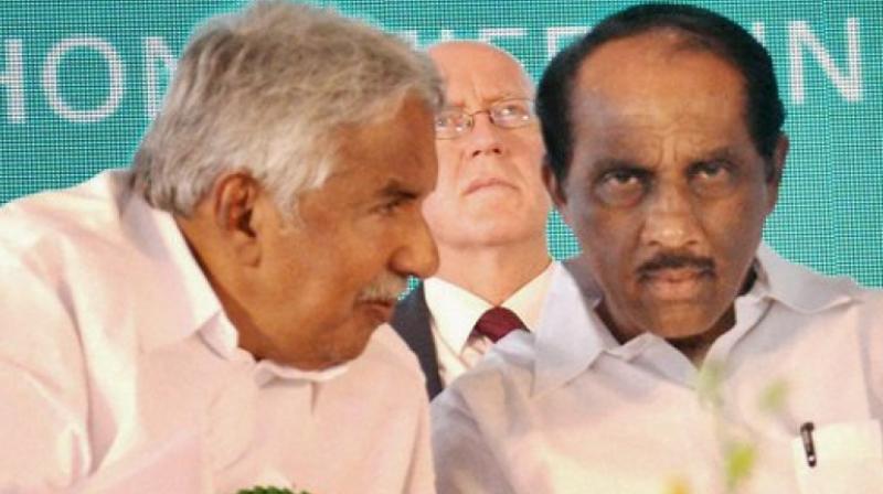 Former Kerala Chief Minister Oommen Chandy with K Babu