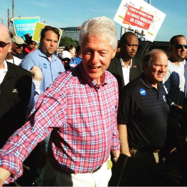 Former President Bill Clinton marches in Detroit's Labor Day parade