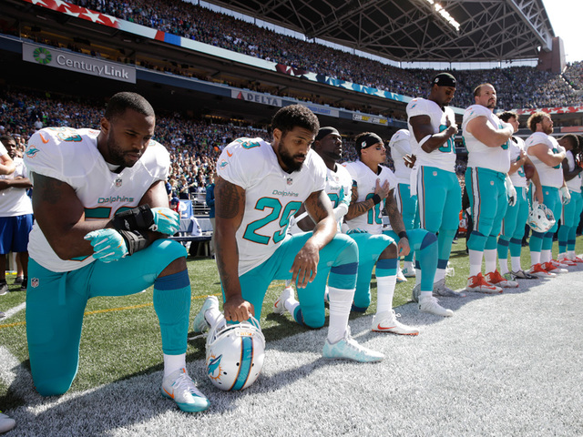 Four Miami Dolphins players kneeled during the national anthem before kickoff against Seattle.                       Stephen Brashear