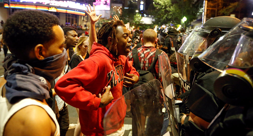 A man speaks to police in uptown Charlotte NC during a protest of the police shooting of Keith Scott in Charlotte North Carolina