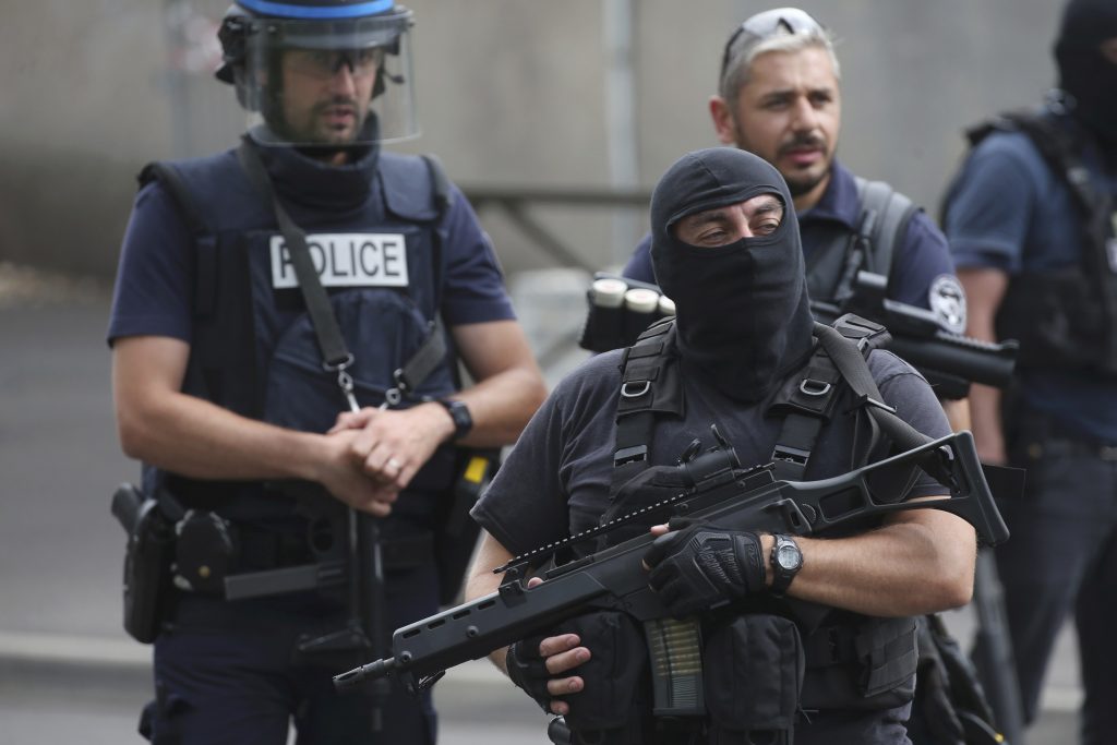 French police and anti-crime brigade members secure a street as they carried out a counter-terrorism swoop at different locations in Argenteuil a suburb north of Paris France July 21