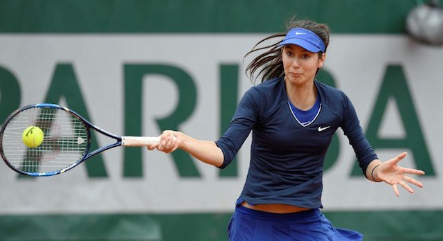 France's Oceane Dodin returns the ball to Serbia's Ana Ivanovic during their women's first round match at the Roland Garros 2016 French Tennis Open in Paris