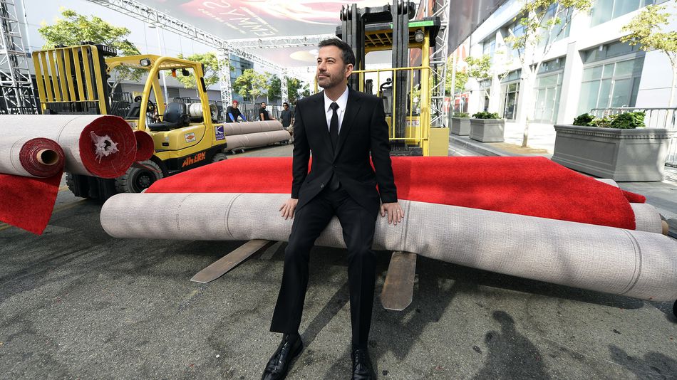 Host Jimmy Kimmel rest on a roll of red carpet during the 68th Emmy Awards press preview day at Microsoft Theater