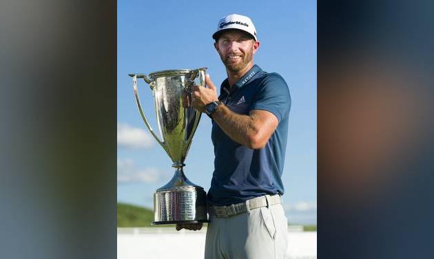 Dustin Johnson poses with his trophy after winning the BMW Championship golf tournament at Crooked Stick Golf Club in Carmel Ind. Sunday Sept. 11 2016