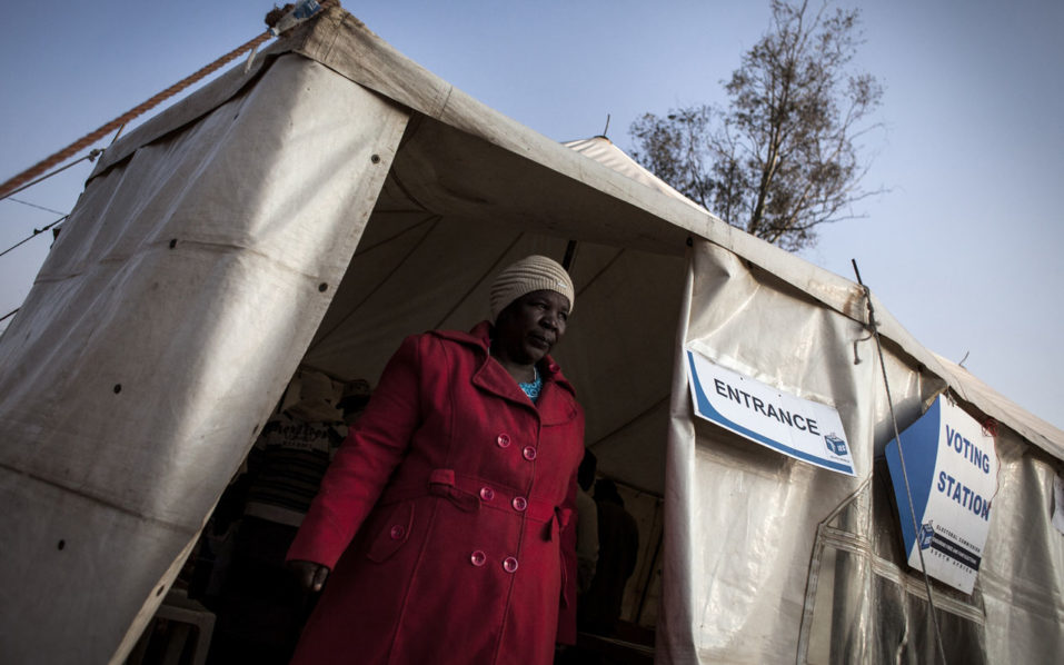 03 2016 shows a woman walking out of a polling station after casting her vote in Meyerton South Africa. African elections are often marred by fraud allegations but on the continent such practices have become flag