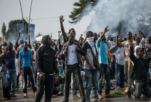 Supporters of Jean Ping demonstrate in front of security forces after incumbent Ali Bongo claimed election victory