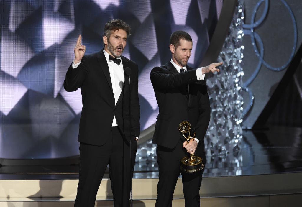 David Benioff left and D.B Weiss accept the award for outstanding writing for a drama series for'Game of Thrones at the 68th Primetime Emmy Awards on Sunday