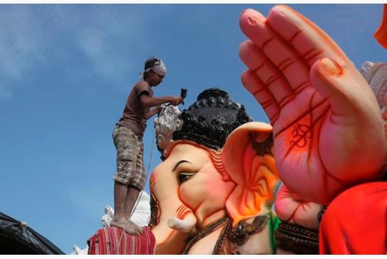 An Indian artist provides final touches to an idol of the elephant headed Hindu god Ganesha before it is carried off for worship to mark Ganesh Chaturthi festival in Hyderabad India Monday Sept. 5 2016. The idol will be immersed in water bodies after