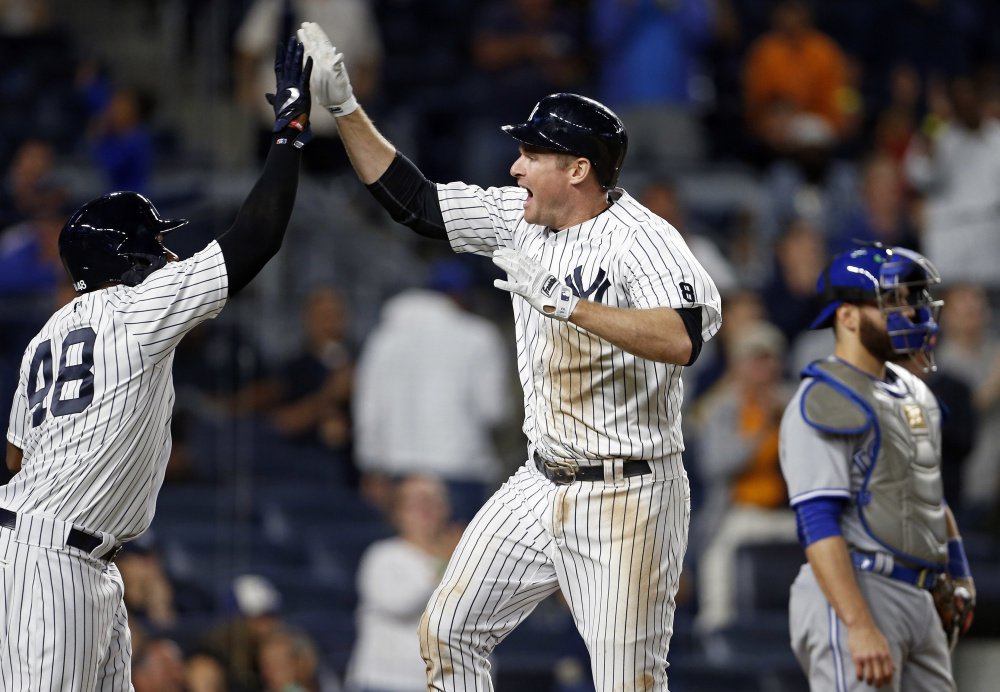 Chase Headley of the New York Yankees celebrates his two-run homer with Eric Young Jr. during the eighth inning of a 7-6 win by the Yankees at New York on Tuesday