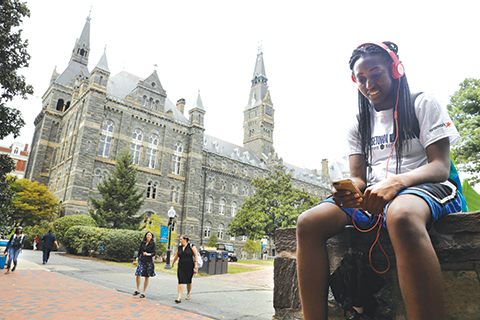 Deja Lindsey 20 a junior at Georgetown University talks on her cell phone in front of Healy Hall on campus Thursday Sept. 1 2016 in Washington. After renaming the Mulledy and Mc Sherry buildings at Georgetown University temporarily to Freedom Hall