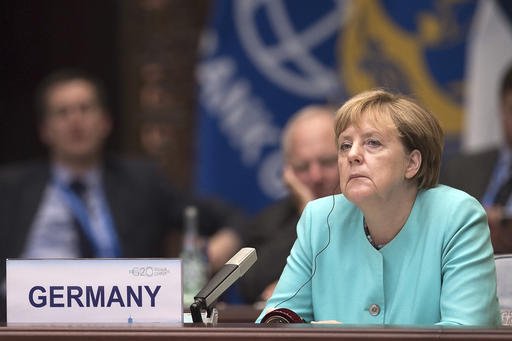 German Chancellor Angela Merkel listens to Chinese President Xi Jinping's speech during the opening ceremony of the G20 Leaders Summit in Hangzhou Sunday Sept. 4 2016