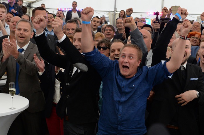 Members and supporters of the AfD party react after first exit polls in Schwerin Germany Sunday Sept. 4 2after the state elections in Mecklenburg Western Pomerania