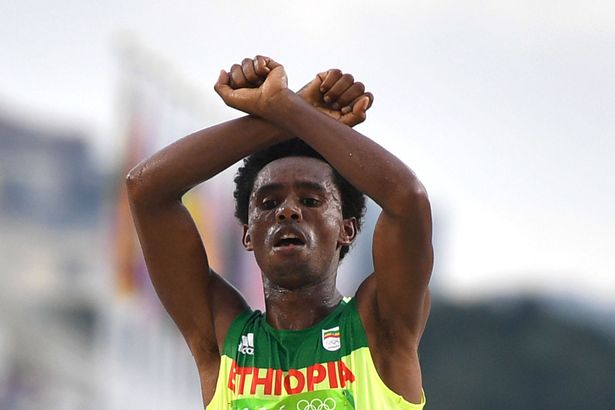 Ethiopia's Feyisa Lilesa crosses the finish line of the Men's Marathon athletics event during the Rio 2016 Olympic Games at the Sambodromo in Rio de Janeiro