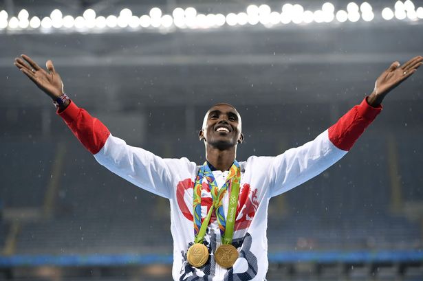 Gold medallist Britain's Mo Farah celebrates on the podium for the Men's 5000m