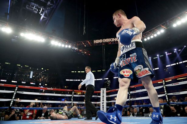 Canelo Alvarez right looks toward Liam Smith left after knocking him down