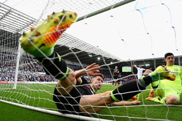 Getty Images

Gary Cahill ends up in the net with the ball after trying to clear Leroy Fer's effort