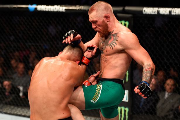 Nate Diaz fights Conor Mc Gregor of Ireland in their welterweight bout during the UFC 202