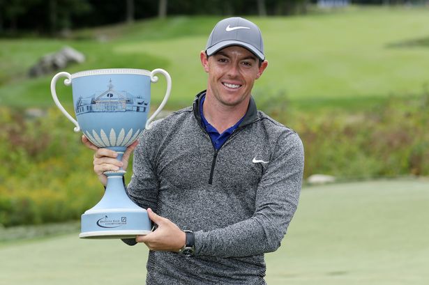 Rory Mc Ilroy poses with the Deutsche Bank Championship trophy