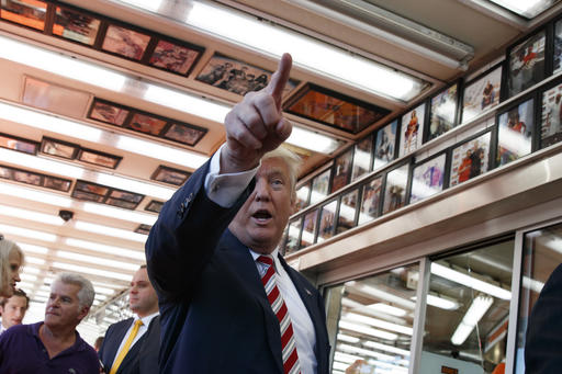 Republican presidential candidate Donald Trump talks with customers during a visit to Geno's Steaks Thursday Sept. 22 2016 in Philadelphia