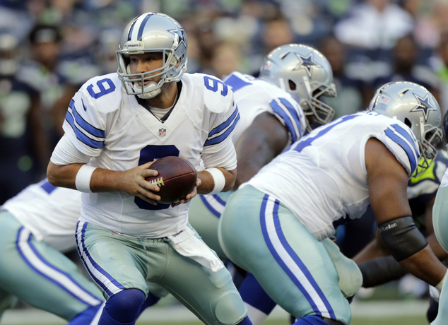 Dallas Cowboys quarterback Tony Romo looks to hand off the ball during the first half of a preseason NFL football