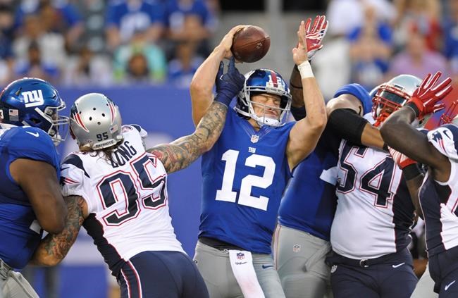 New York Giants quarterback Ryan Nassib protects the ball from New England Patriots&#39 Chris Long and Dont'a Hightower during the first half of a preseason NFL football game Thursday Sept. 1 2016 in East Rutherford. Hightower sacke