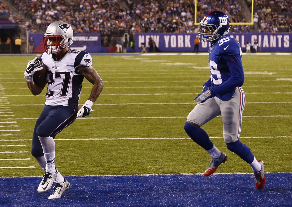 EAST RUTHERFORD NJ- SEPTEMBER 01 D.J. Foster #27 of the New England Patriots runs in for a touchdown in front of Michael Hunter #39 of the New York Giants during a preseason game at Met Life Stadium