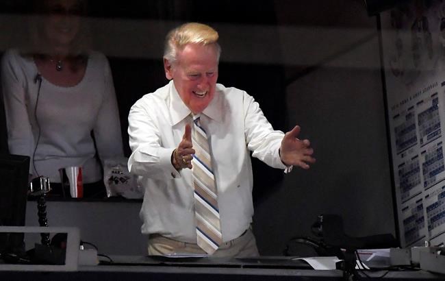 Los Angeles Dodgers&#039 Hall of Fame announcer Vin Scully gestures to fans during the seventh inning of a baseball game between the Los Angeles Dodgers and the San Francisco Giants Monday Sept. 19 2016 in Los Angeles